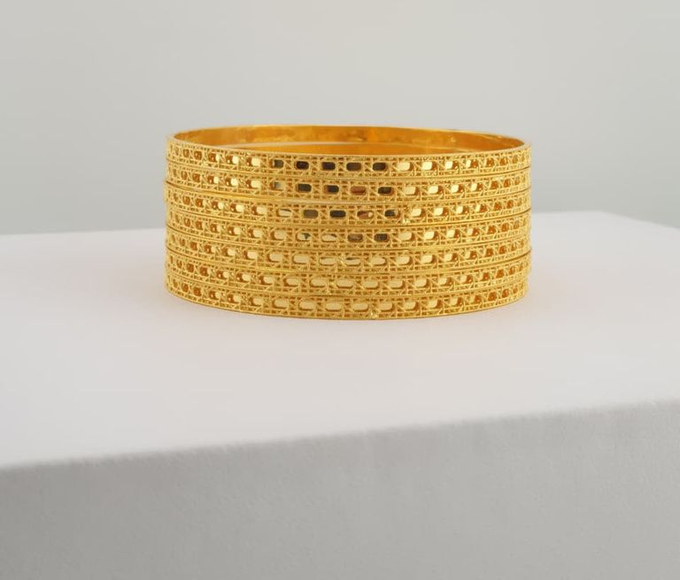 Stack of handcrafted gold bangles